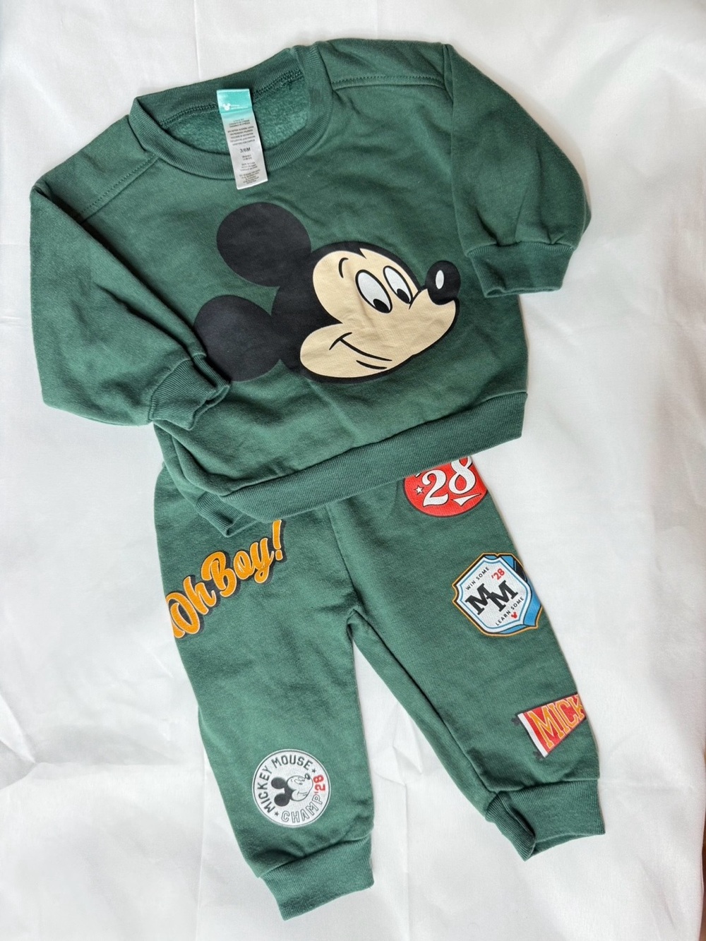 Green Disney children's outfit with a large Mickey Mouse image on the sweatshirt